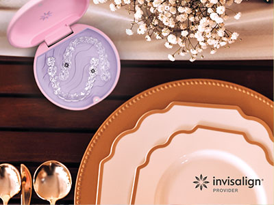An advertisement featuring a table setting with a purple toothbrush, plates, and a spoon, emphasizing dental care products on a dining table with a pink lid.